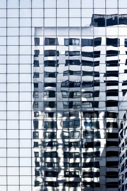 Reflections in a blue glass skyscraper